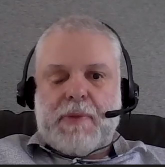 Screen shot of Vaughan wearing a headset during an online board meeting.